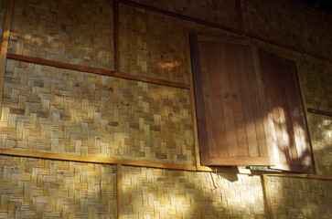 Wooden windows and woven bamboo walls are the design of a Thai rural house.