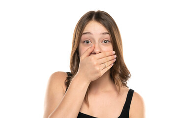 Shocked Embarrassed Young Woman Covering Mouth On A White Background