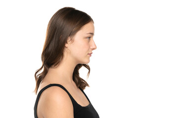 Profile of a beautiful young women with long hair and no makeup on a white background.
