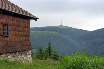 Old hunting wooden cottage in Jeseniky mountains on a  summer cloudy day