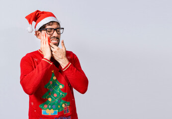 Man in christmas sweater with toothache, Young man in christmas hat with toothache isolated, Man in...