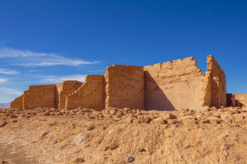 Ruins of abandoned houses in a mining ghost town from the nitrate era in the Atacama desert in the...