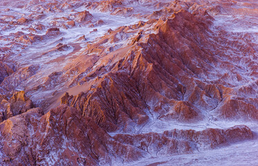 Barren desert landscape with eroded badlands and white crusts of salt in the Moon valley (Valle de la Luna) in the vicinity of San Pedro de Atacama 