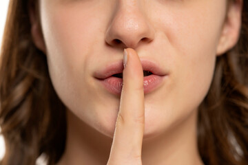 woman lips with finger asking for silence