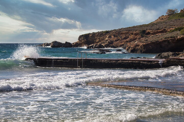 Dramatic Seascape. Waves crashing on Pear at Syros Island's Mediterranean shore. Stock Image.
