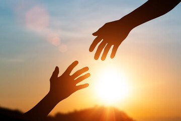 Silhouette of helping hand and develop a friendship. international day of peace concept. helping...