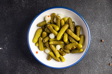 gherkin salted cucumbers pickled vegetable delicious snack mortadella, pistachios, ham healthy meal food snack diet on the table copy space food background rustic top view