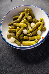 gherkin salted cucumbers pickled vegetable delicious snack mortadella, pistachios, ham healthy meal food snack diet on the table copy space food background rustic top view