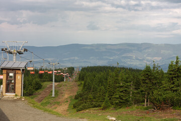 Fototapeta na wymiar Empty chairlift in Jesenik mountains, upper station of chairlift