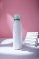 White deodorant body spray or shower foam bottle on pink background mockup template, container with no brand in harsh light