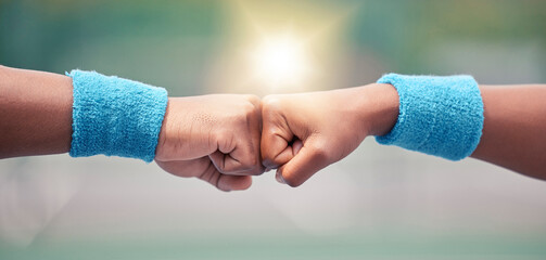 Tennis, closeup and fist bump for success, motivation and teamwork with blurred background while...