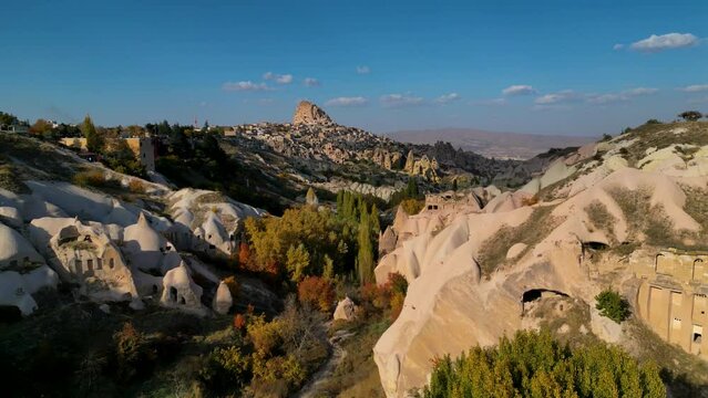 flying over Pigeon valley and U&ccedil;hisar Castle on background - Cappadocia, Turkey