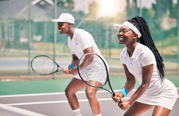 Tennis, sports and competition with a black woman and doubles partner playing a game on a court outdoor together. Fitness, team and exercise with a man and female tennis player at a venue for sport