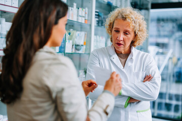 Woman showing pharmacist prescription.