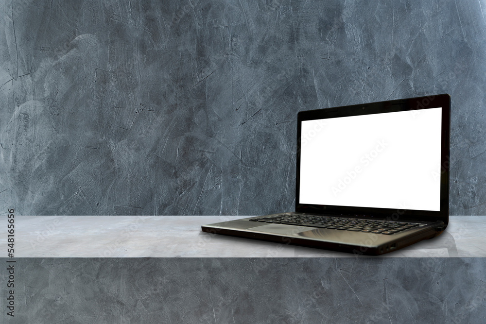 Poster laptop computer on grey shelf background.. concrete shelves table isolated on dark loft background