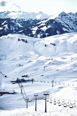 Vertical image of the ski slope with the ski lift on the Alps summit