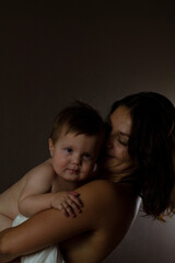 mother holding a baby boy. pure motherhood