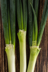 green onions on wooden background