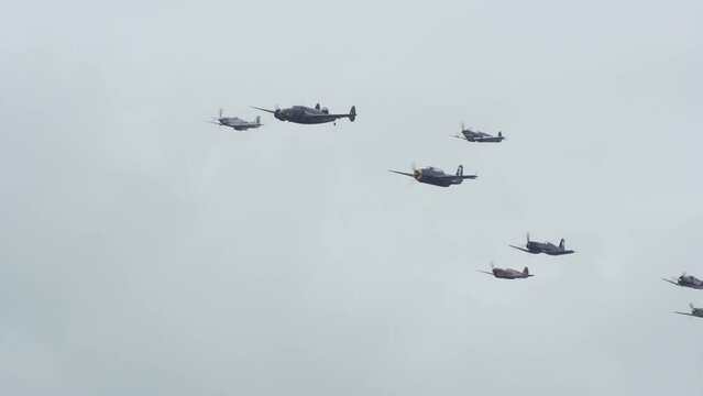 World War 2 bombers & fighter planes fly in formation