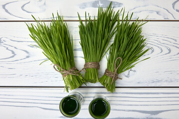 View from above of juicy bright freshly cut bunches of wheat neatly tied with jute rope. Wheatgrass...
