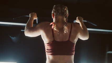 A Motivated Athlete Using Pullup Bar to Lift her Body Up and Exercise her Arms. Female Professional...