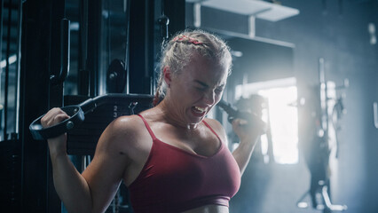 A Persistent Female Bodybuilder Enduring the Workout Pain of Exercising. Portrait of a Woman...