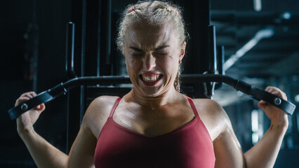 An Agile Future Champion Training by Using Lat Pull Down Machine and Sweating in a Dark Gym. The...