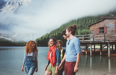 Fototapeta na wymiar Group of teens spending time on the lake beach