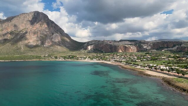 Drone view of the Mediterranean coast and Monte Cofano mountain. Turquoise sea and sunny morning. Custonaci. Sicily. Italy