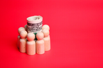 a wooden figure surrounding a banknote. the concept of financial protection or teamwork financial management