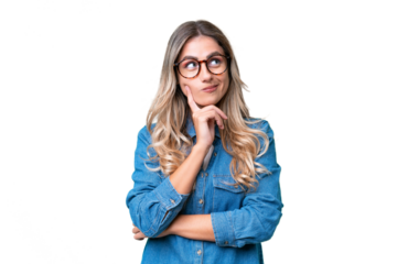 Young Uruguayan woman over isolated background thinking an idea while looking up