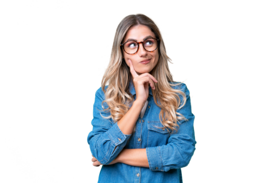 Young Uruguayan woman over isolated background thinking an idea while looking up