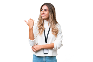 Young Uruguayan woman with ID card over isolated background pointing to the side to present a product