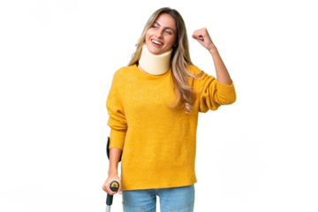 Young Uruguayan woman wearing neck brace and crutches over isolated background celebrating a victory