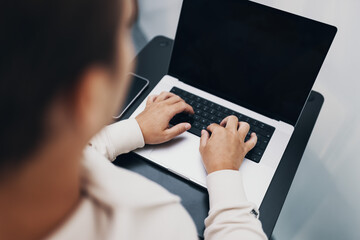 closeup of hands typing on a notebook, keyboard