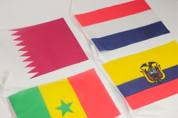 Leather soccer ball with international team flags of the participating countries in the championship tournament isolated on white background. Football equipment competitive game. World cup concept.
