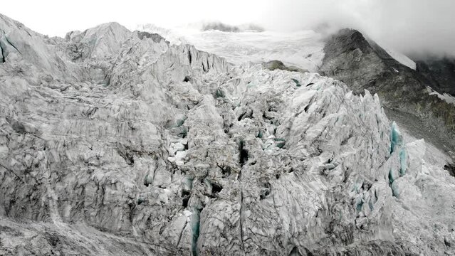 Aerial flyover into and through crevasses of the Moiry glacier near Grimentz in Valais, Switzerland afternoon