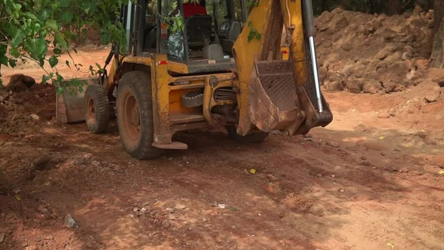 JCB Bulldozer engaged in collecting clay after digging