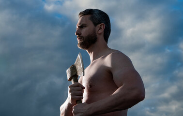 shirtless man with axe. caucasian woodsman man hold ax. brutal man on sky background