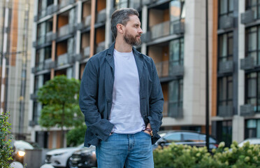 stylish fashion model man hold hands in pockets. unshaven man in stylish clothes.