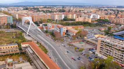 Obraz premium Aerial view of the Settimia Spizzichino bridge known as Ostiense overpass. This iron arch bridge is located in the Garbatella district in Rome, Italy