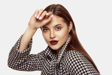 Portrait of young beautiful girl posing in stylish jacket isolated over white background. Autumn...