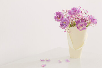 bouquet of pink tulips and gypsophila on white table
