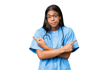 Young African american nurse woman over isolated background pointing to the laterals having doubts