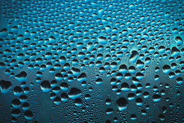 raindrops on the window glass with sparkles of street light