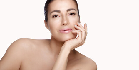 Beautiful middle-aged model in a skincare concept. Beauty panorama banner with lateral white...