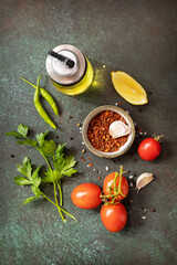 Healthy food vegetarian food background. Various herbs and spices for cooking on dark background. View from above.