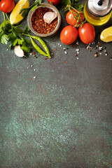 Healthy food vegetarian food background. Various herbs and spices for cooking on dark background. View from above. Copy space.