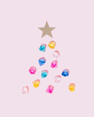 Colorful diamonds on pink background with mirror star. Christmas tree aesthetic decoration. Jewelry concept.