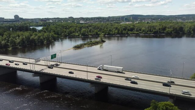 Scenic aerial view of busy Quebec Autoroute 50 over the river at sunset, Gatineau, Quebec, Canada